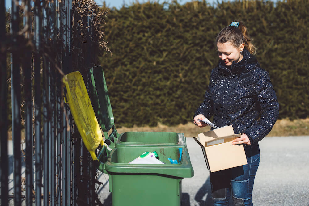 Blonde Girl Near a Trash Can