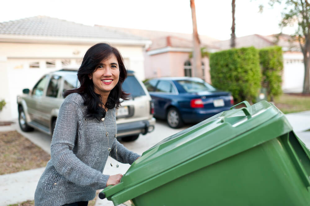 Smiling Lady with a Trash Can